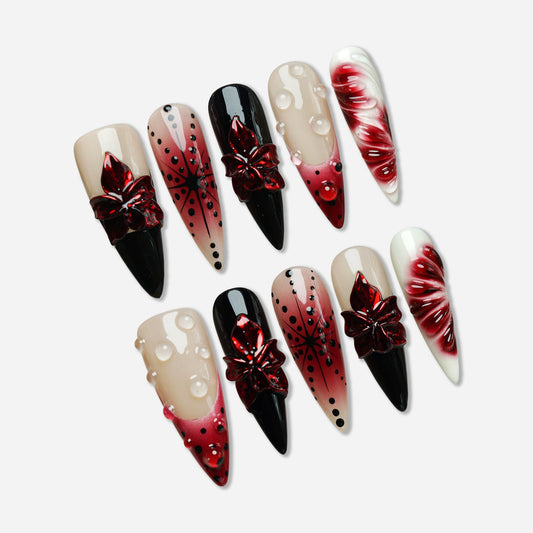 Rouge Relic press-on nail set by Donailsart – nude and deep rouge jelly nails with glossy black contrast, sculpted floral accents, and clear gel droplets