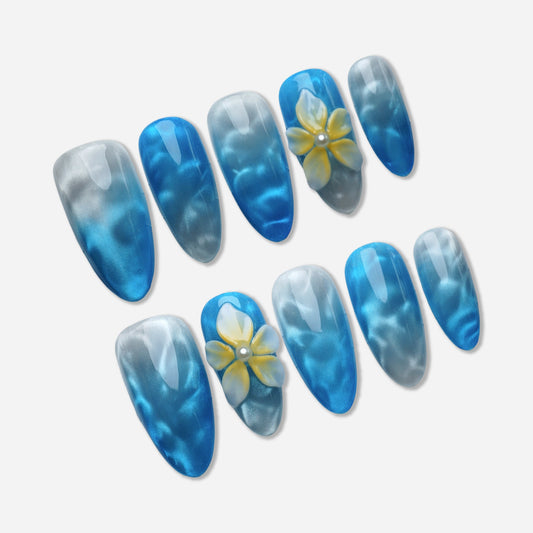 A21 | Sea Mist Flower press-on nail set by Donailsart – soft blue gradient nails with cloudy white wave-like textures and delicate floral accents