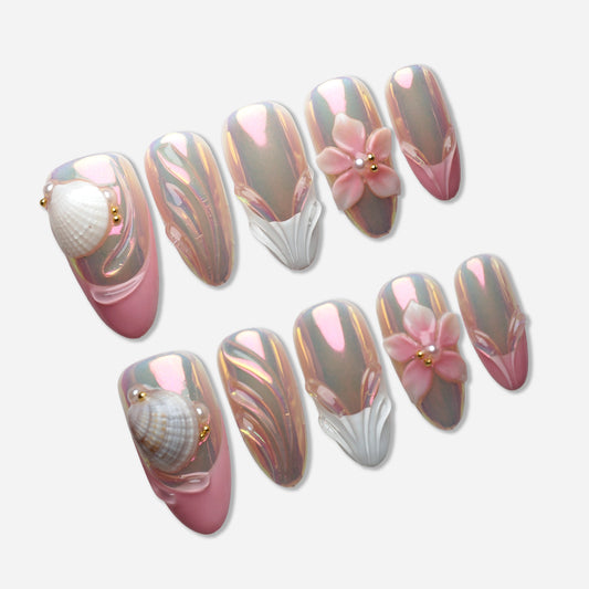 A20 | Shell Aura press-on nail set by Donailsart – iridescent chrome nails shifting between soft pink and gold, with sculpted shell details and delicate floral accents