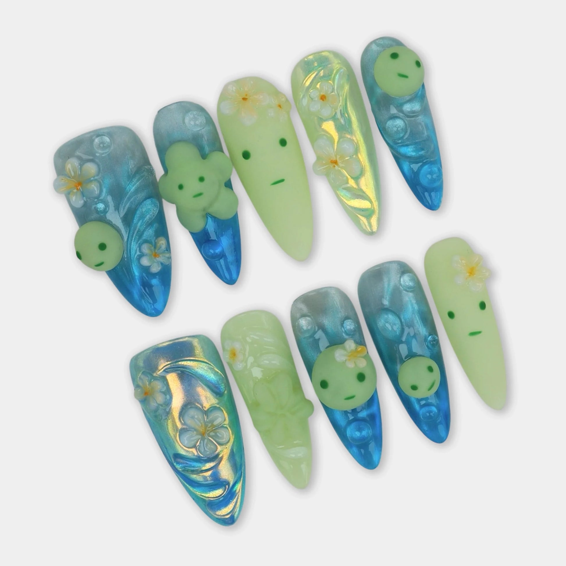 Cute smiski nails with translucent blue shimmer, 3D Smiski-inspired faces, and tropical flower details
