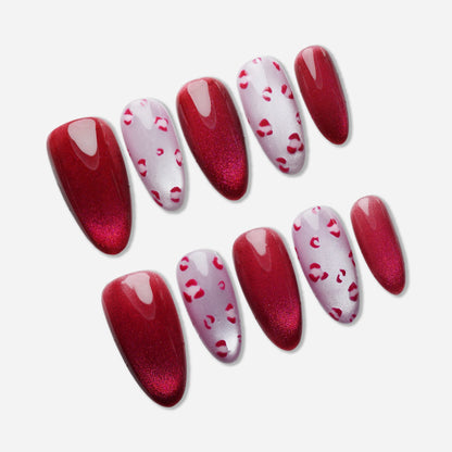 B8 | Sugar Kisses press-on nail set by Donailsart – glossy crimson red shimmer nails with soft pink tones and subtle leopard print accents