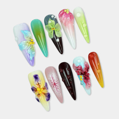 Multicolor press-on nails with 3D flowers, water droplets, and gradient effects in pastel and jewel tones from Donailsart