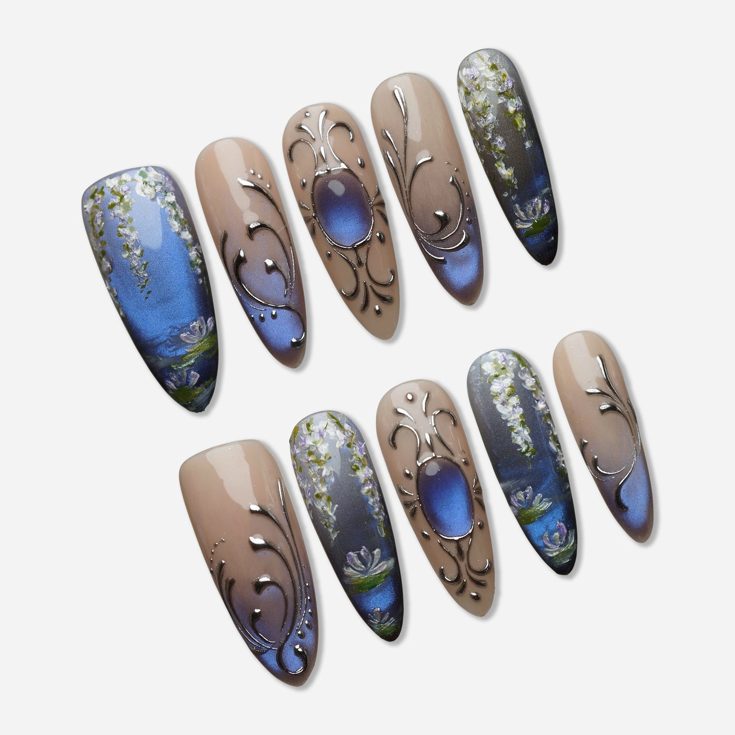 Velour Relic press-on nail set by Donailsart – muted nude nails with deep blue-violet gradient, fine chrome line details, and antique-inspired floral accents