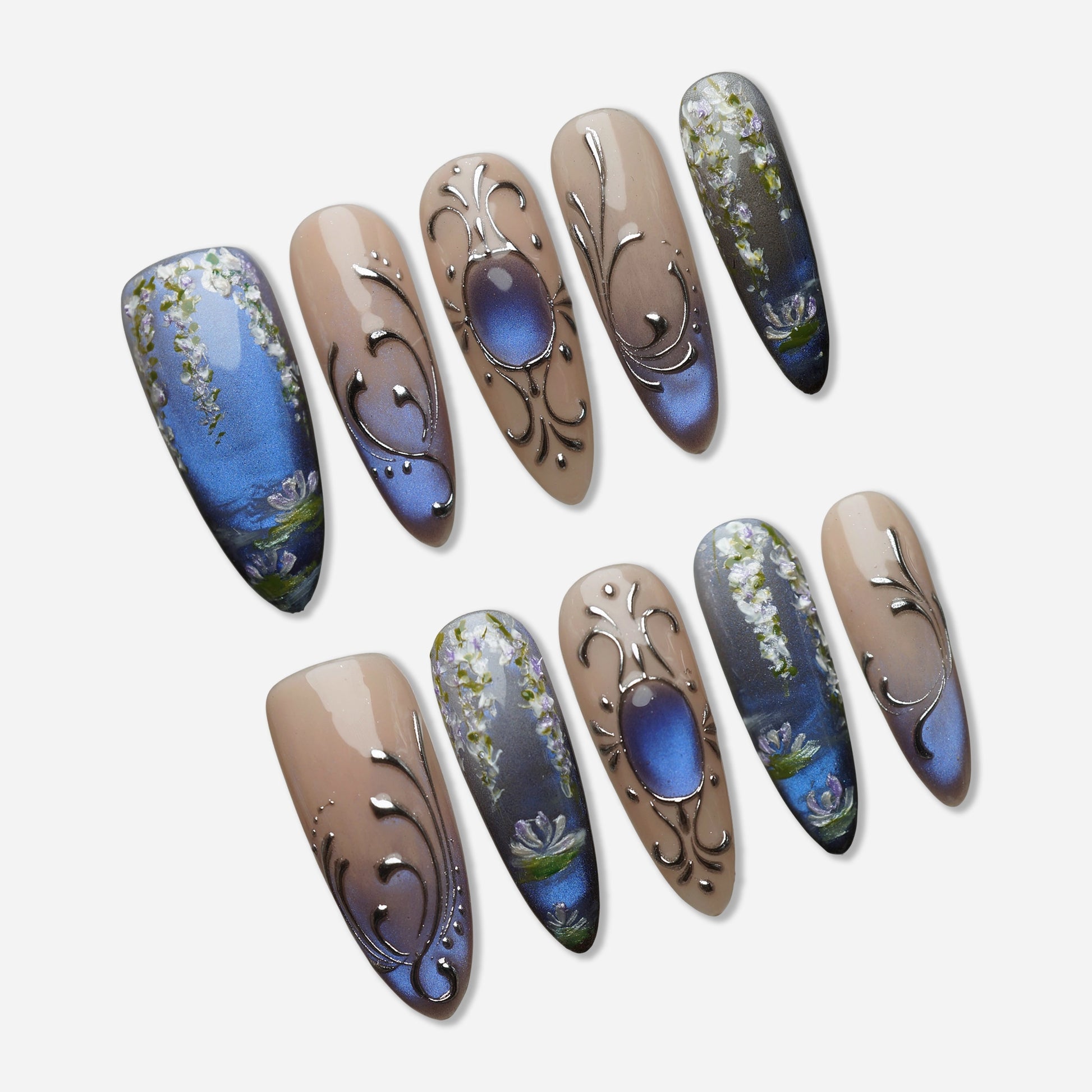 Velour Relic press-on nail set by Donailsart – muted nude nails with deep blue-violet gradient, fine chrome line details, and antique-inspired floral accents