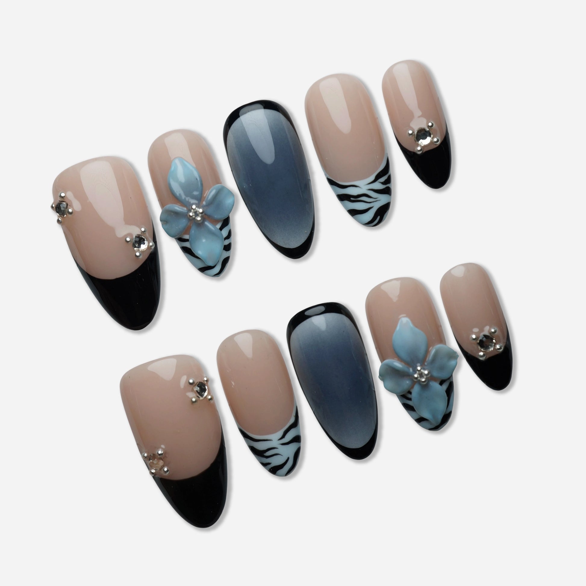 B1 | Velour Static press-on nail set by Donailsart – soft nude and cool blue nails with 3D floral accents, refined zebra print details, and glossy black tips