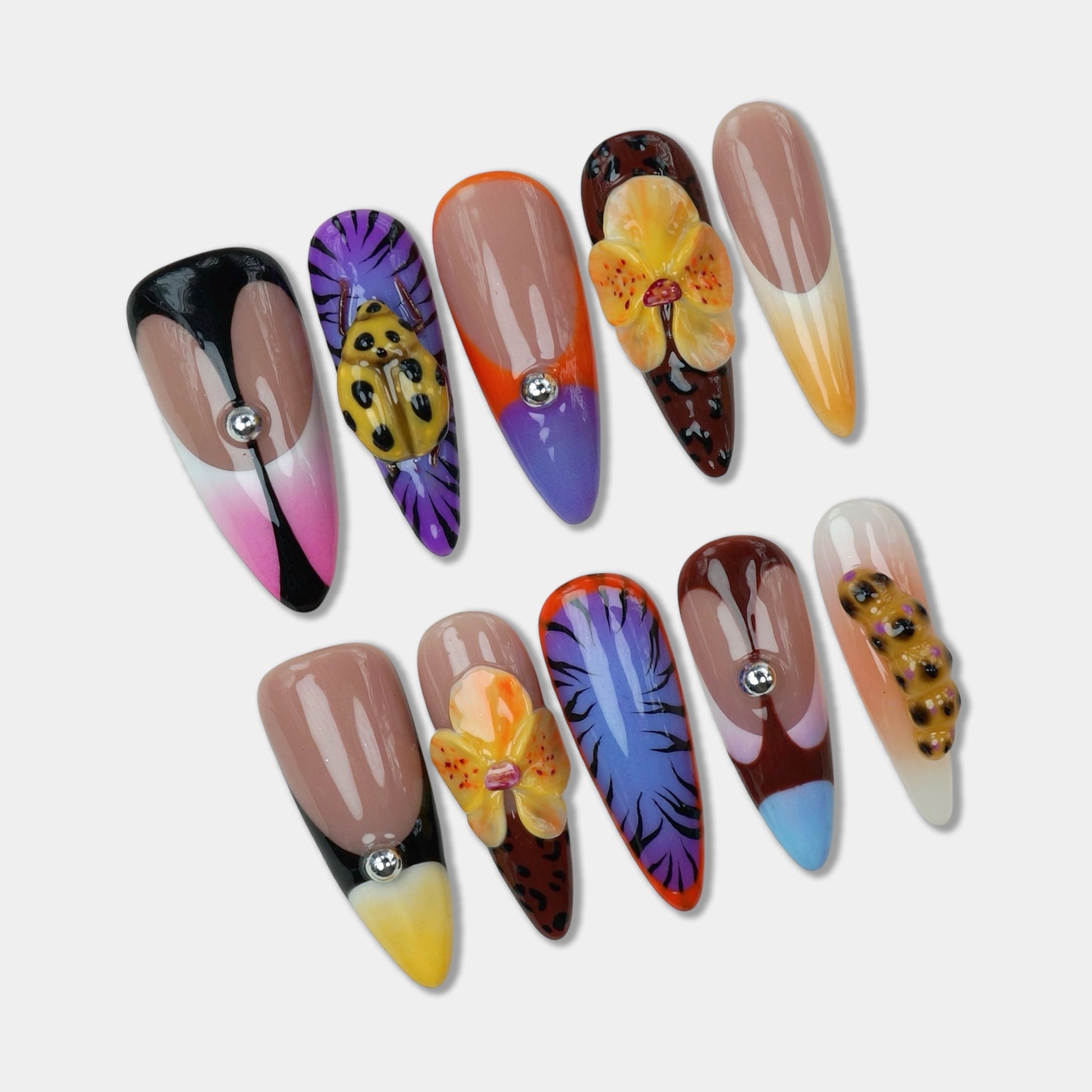 Tropical-inspired press-on nails from Donailsart featuring exotic flowers, passion fruit details, and animal print designs