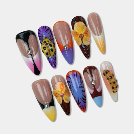 Tropical-inspired press-on nails from Donailsart featuring exotic flowers, passion fruit details, and animal print designs