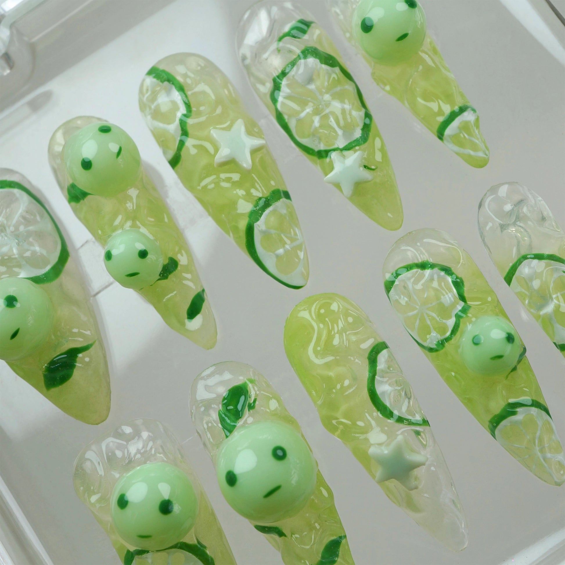 Cute smiski press-on nails from Donailsart with glow-in-the-dark green characters, star details, and soft lemony hues